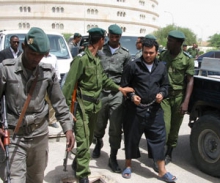 ولد السمان خلال اقتياده للمحاكمة 2007